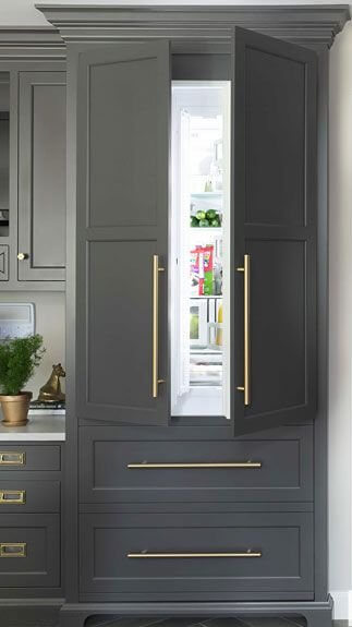 Stylish refrigerator disguised as part of kitchen cabinets.